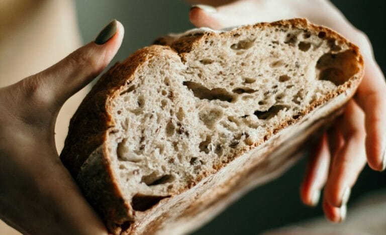 Close-up of a freshly baked artisan bread with an airy, open crumb.