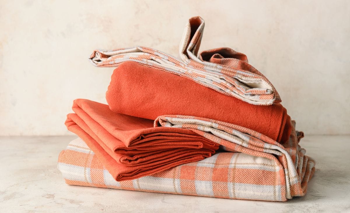 Folded orange bed sheets.
