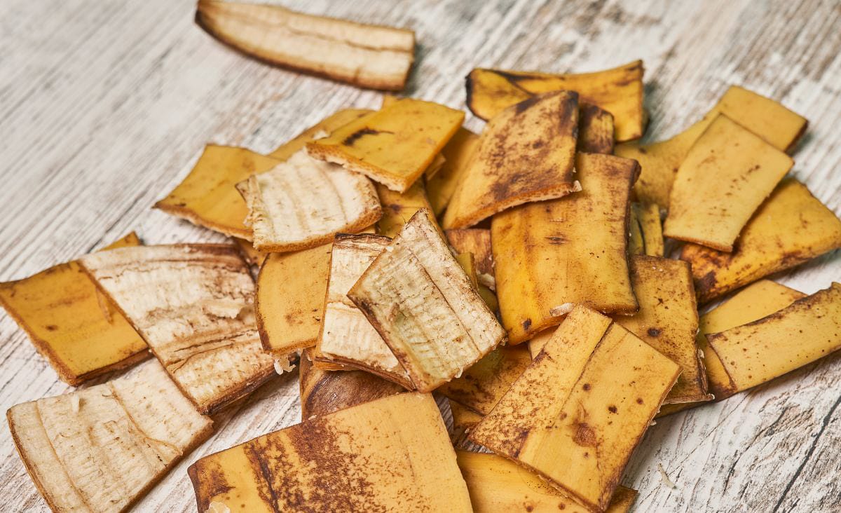 Close-up of dried banana peels scattered on a wooden surface.