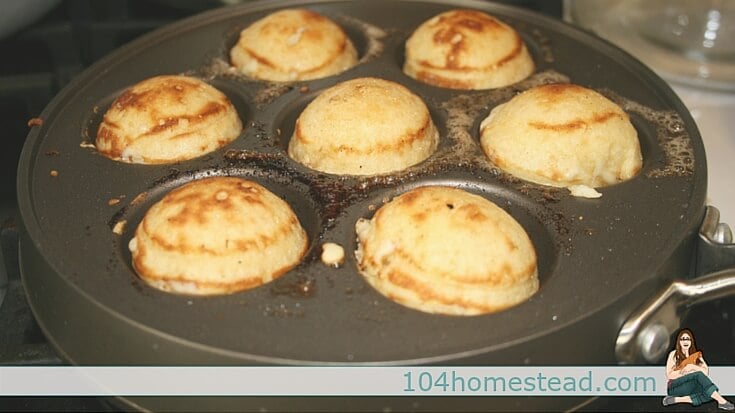 The word Ebelskiver is Danish for apple slices, but the meaning is a dessert or snack similar to a pancake, but with a flakier texture and round shape.