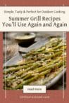 Char-grilled asparagus topped with lemon slices and Parmesan cheese, served on a rustic plate.