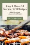 Tongs lifting a grilled sausage over a BBQ loaded with sizzling meats and vegetables.