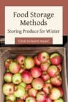 A wooden crate filled with red and green apples, showing fresh produce ready for winter storage.