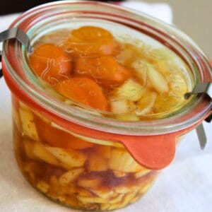 A jar of homemade fire cider infusing.