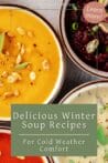 Three bowls of colorful soups—red tomato, yellow squash, and green broccoli—surrounded by fresh vegetables and herbs on a wooden table.