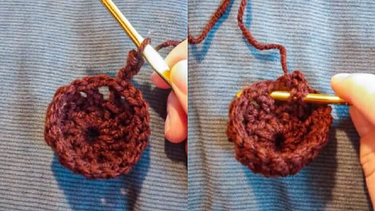 A small brown crochet circle in the early rounds of the pattern, with a gold crochet hook inserted to show where to work the next stitch.