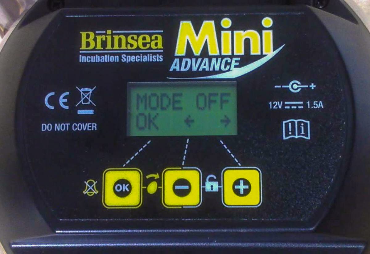Control panel of Brinsea Mini 2 Advance incubator showing digital screen and buttons for temperature and turning settings.