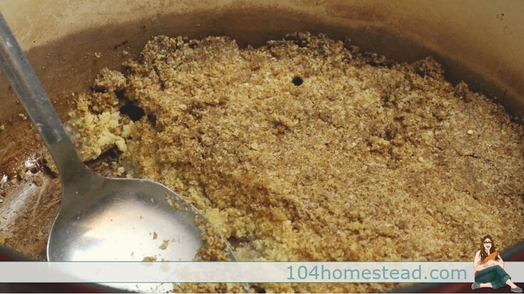 Sprinkling the crumb topping over the sliced apples.