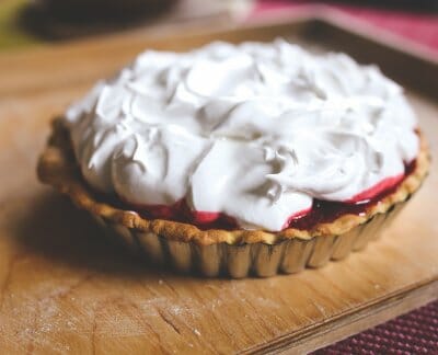 Strawberry tart with whipped cream on top.