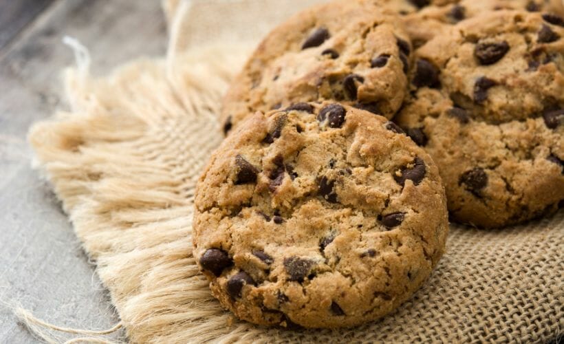 Bacon chocolate chip cookies laid out on a burlap napkin.