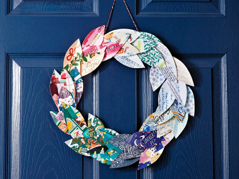 A wreath made of christmas card paper leaves.