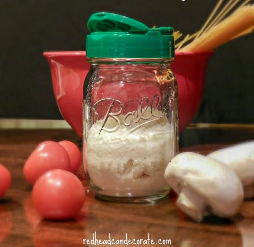 A mason jar with a parmesan cheese shaker lid on top.