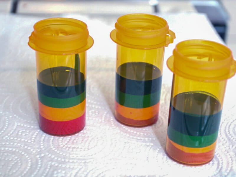Crayon wax melted in pill bottles in a variety of colors.