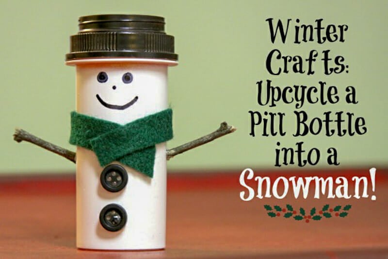 A little snowman with a green scarf made from a pill bottle.