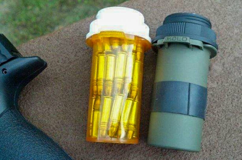 A painted and unpainted pill bottle holding ammo.