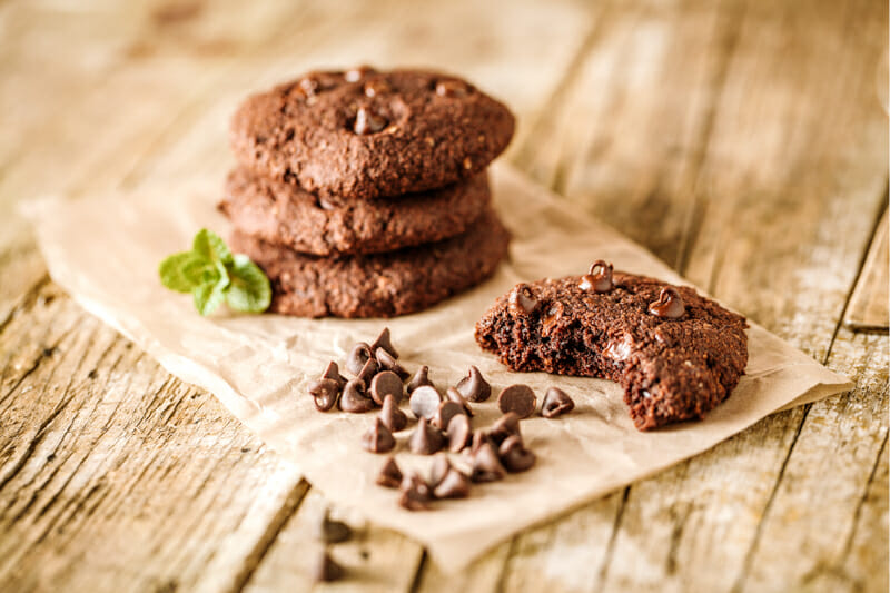 Gluten-free double chocolate chip cookies on parchment paper.