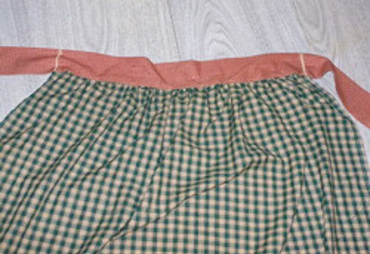 Backside view of gathered DIY harvest apron showing waistband and pleats.