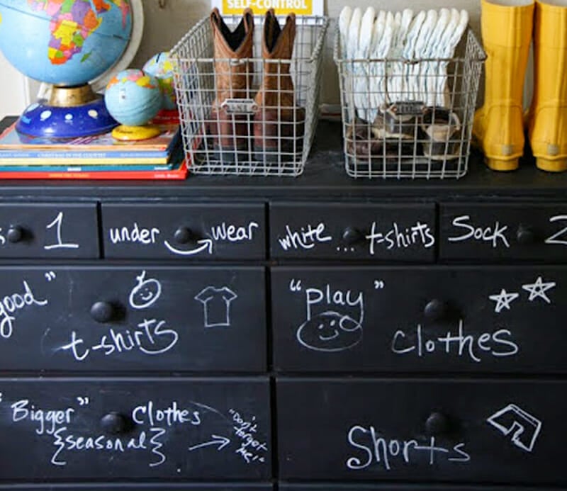 A dresser painted in chalkboard paint with the drawers labeled with what's inside.