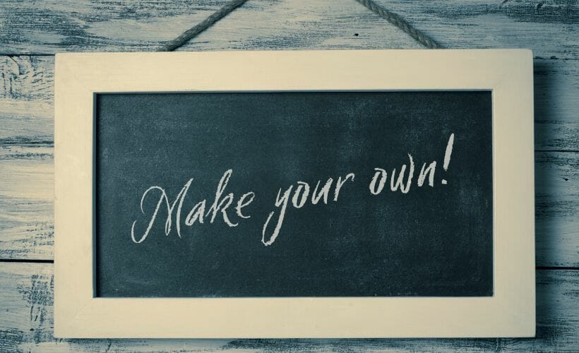 A chalkboard with "make your own" written on it.