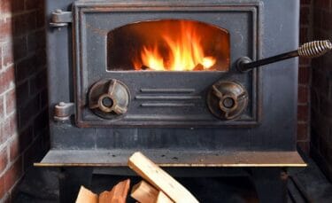 A wood burning stove with a clean glass front.