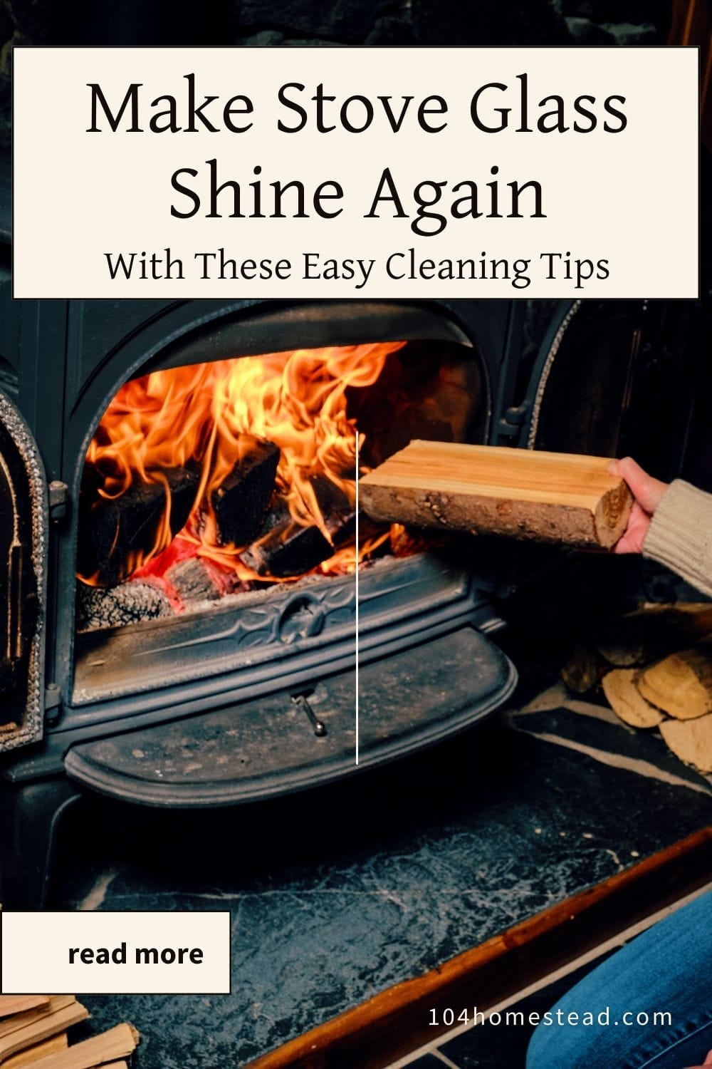 A hand placing wood into a stove with clear glass and vibrant flames, highlighting a well-maintained stove.