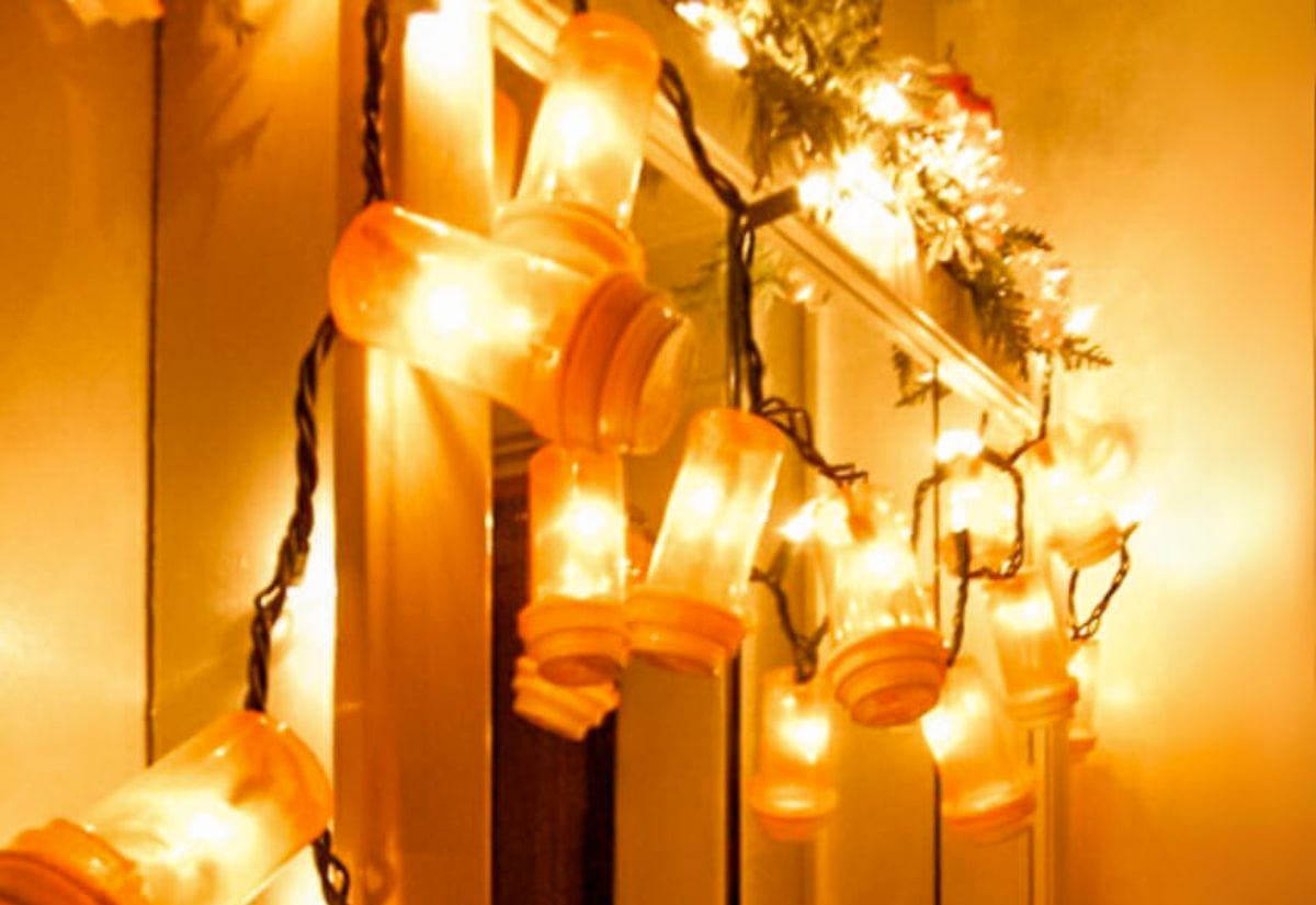 String lights threaded through empty pill bottles, glowing warmly as DIY party lights.
