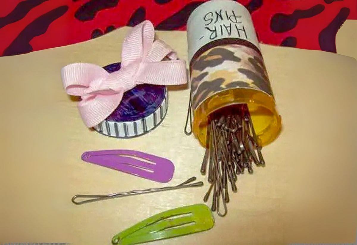 Prescription pill bottle decorated with patterned tape, filled with bobby pins and hair clips, with the lid labeled “Hair Pins.”