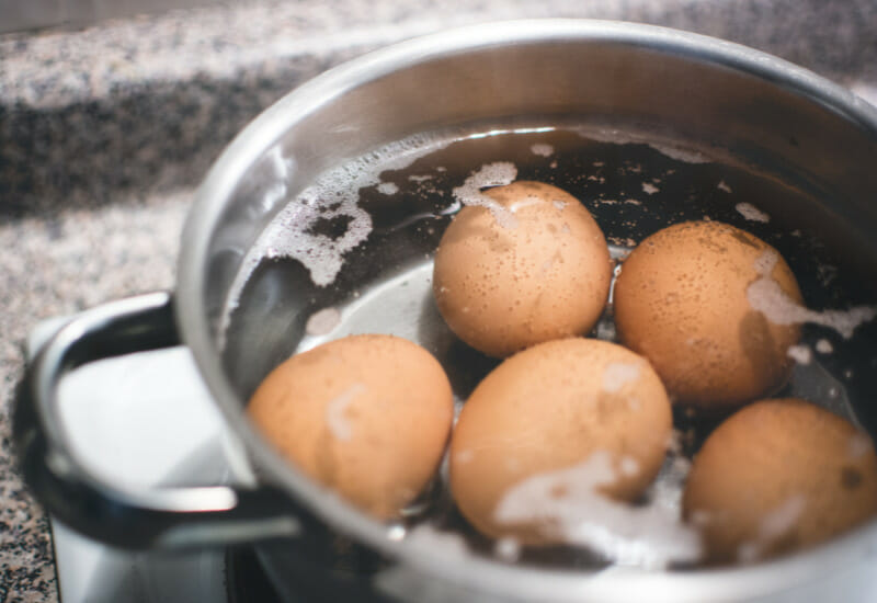 A saucepan with water and farm fresh eggs.
