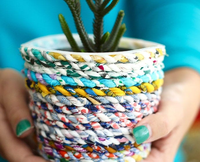An planter made from plastic containers and homemade fabric scrap yarn.