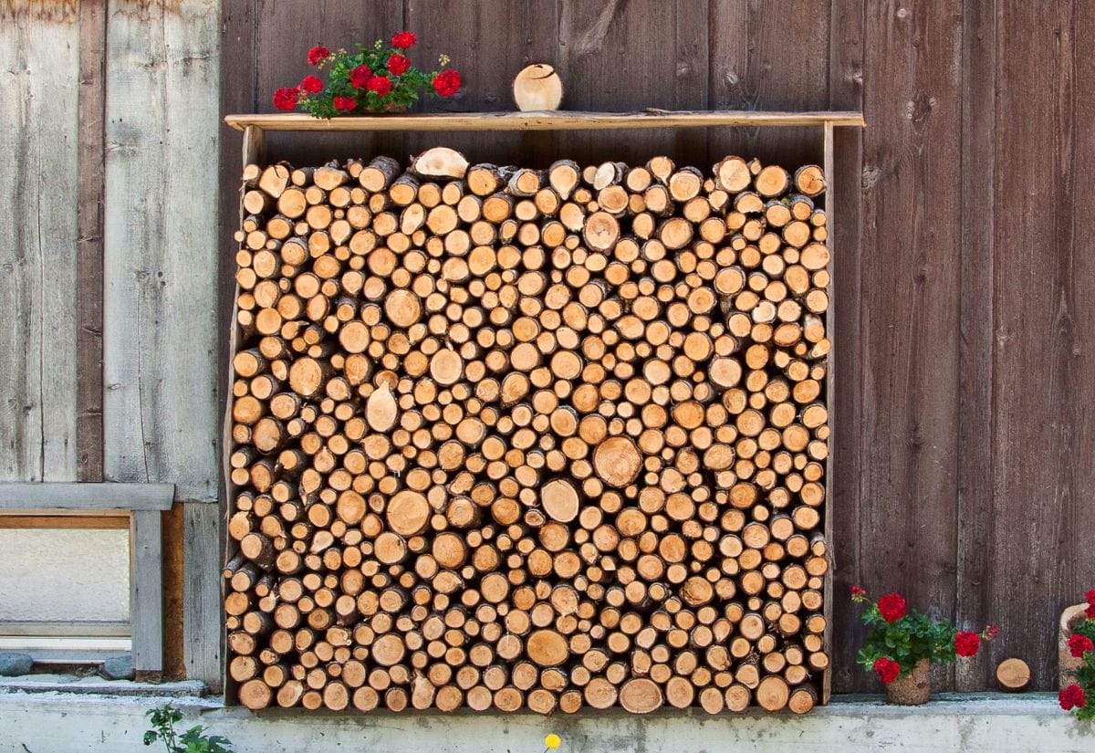 A simple outdoor wood rack with plywood roof to keep firewood dry.