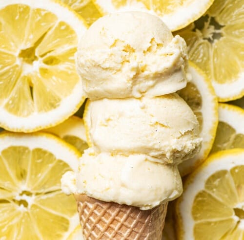 Honey ice cream in a cone with a background of lemon slices.