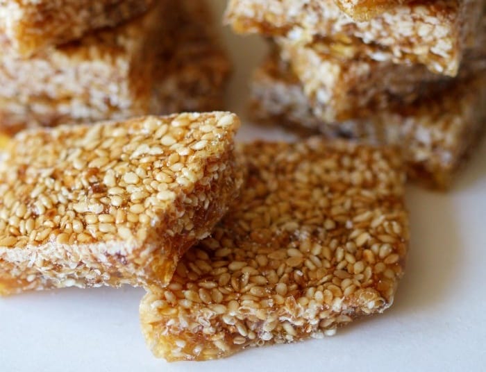 Bars of honey crunch candy arranged in a pile on a plate.