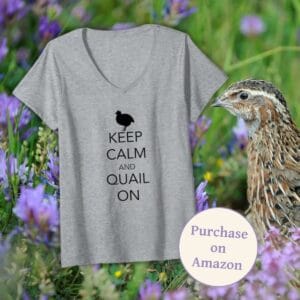 Gray v-neck T-shirt featuring the phrase "Keep Calm and Quail On" with a small quail silhouette, displayed against a background of purple wildflowers with a quail standing nearby. A circular badge highlights "Purchase on Amazon."