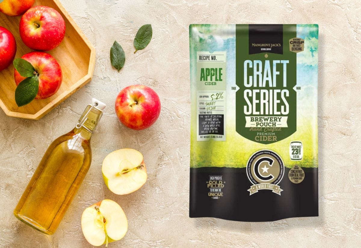 Mangrove Jack's Craft Series Hard Apple Cider Kit surrounded by apples and a bottle of hard cider.