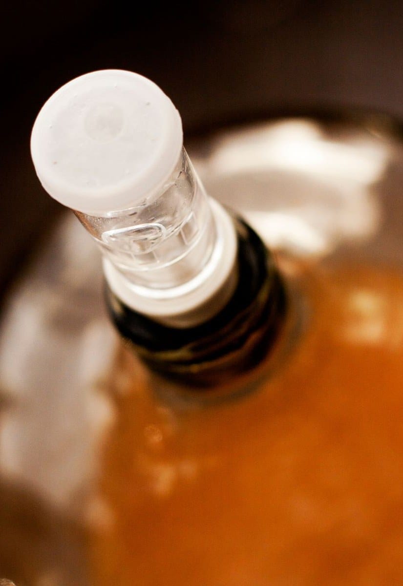 A top view of cider fermenting in a glass carboy.