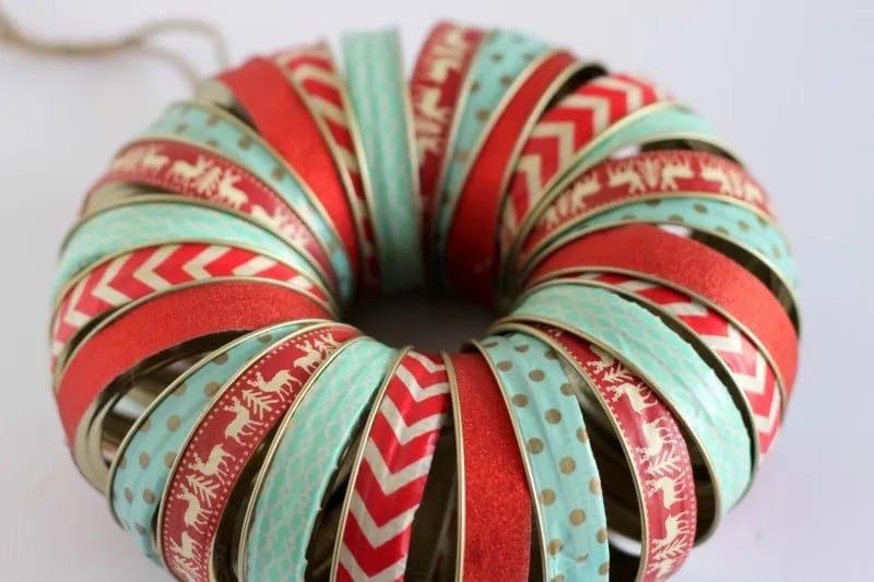 A holiday-themed wreath made from canning jar rings.