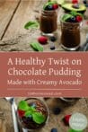 Two glasses of chocolate pudding topped with mint and berries, served on a rustic wooden table for a delicious and healthy dessert.