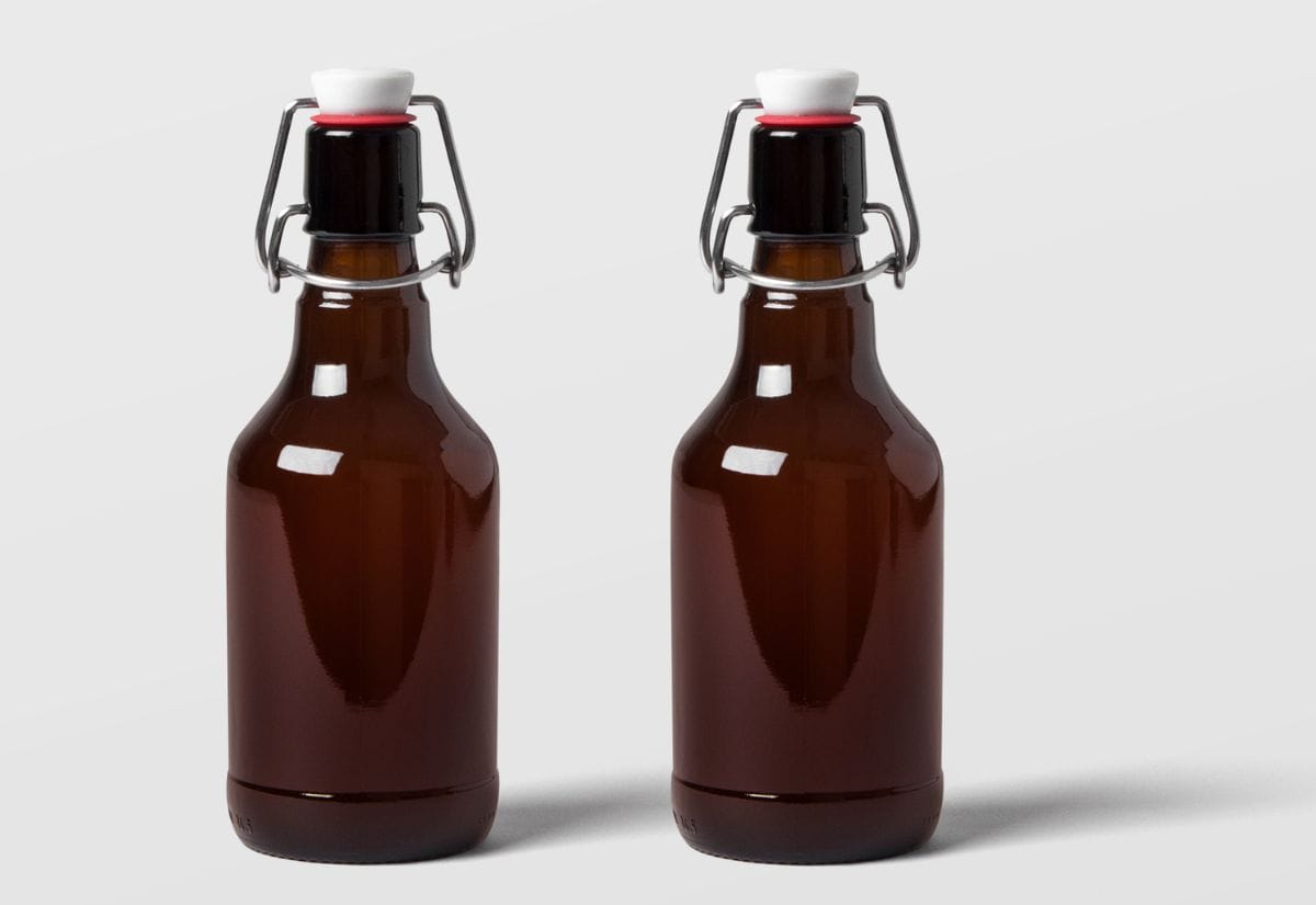 Two amber glass swing-top bottles, perfect for bottling and carbonating homebrewed beer.