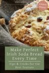 A close-up of a freshly baked Irish soda bread loaf, showcasing its golden, textured crust with raisins peeking through.